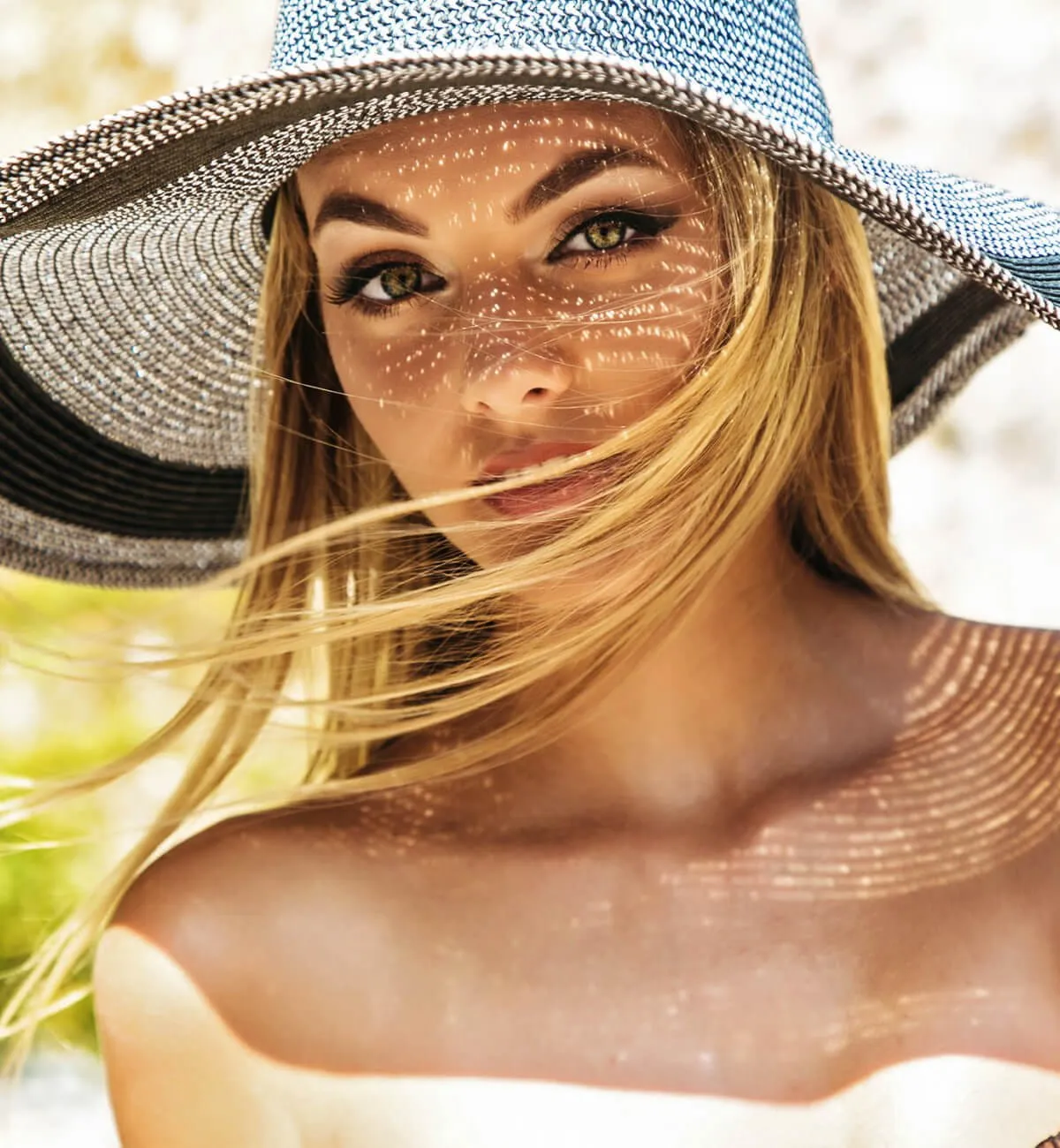 Blonde woman in black and white sun hat
