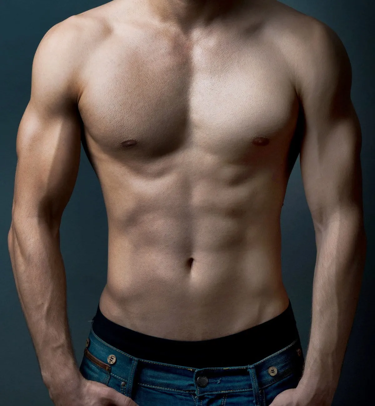 Topless man with chiseled abs wearing jeans